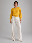 Women's sweater featuring stylish lantern sleeves, a cozy cable knit design, and a comfortable crew neck, available in five vibrant colors. 3