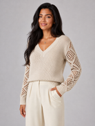 Women's sweater featuring open mesh sleeves and a stylish V-neck design, made from soft brushed knit for a relaxed fit, perfect for casual or layered outfits. 8