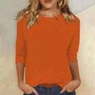 Women's relaxed fit top featuring 3/4 sleeves and a classic crew neck, perfect for casual everyday wear. 7