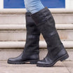 Women's waterproof knee high boots in black vegan leather featuring double buckle straps and an easy pull-on design, perfect for stylish and practical footwear in wet weather. 1