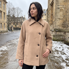 Women’s oversized wool blend coat featuring front button fastening, perfect for winter fashion and warmth. 1