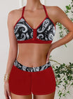 Womens bikini set featuring a halter top and short-style bottoms in a vibrant tropical print, perfect for beach days and summer vacations. 1