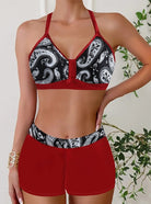 Womens bikini set featuring a halter top and short-style bottoms in a vibrant tropical print, perfect for beach days and summer vacations. 1