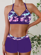 Womens bikini set featuring a halter top and short-style bottoms in a vibrant tropical print, perfect for beach days and summer vacations. 3