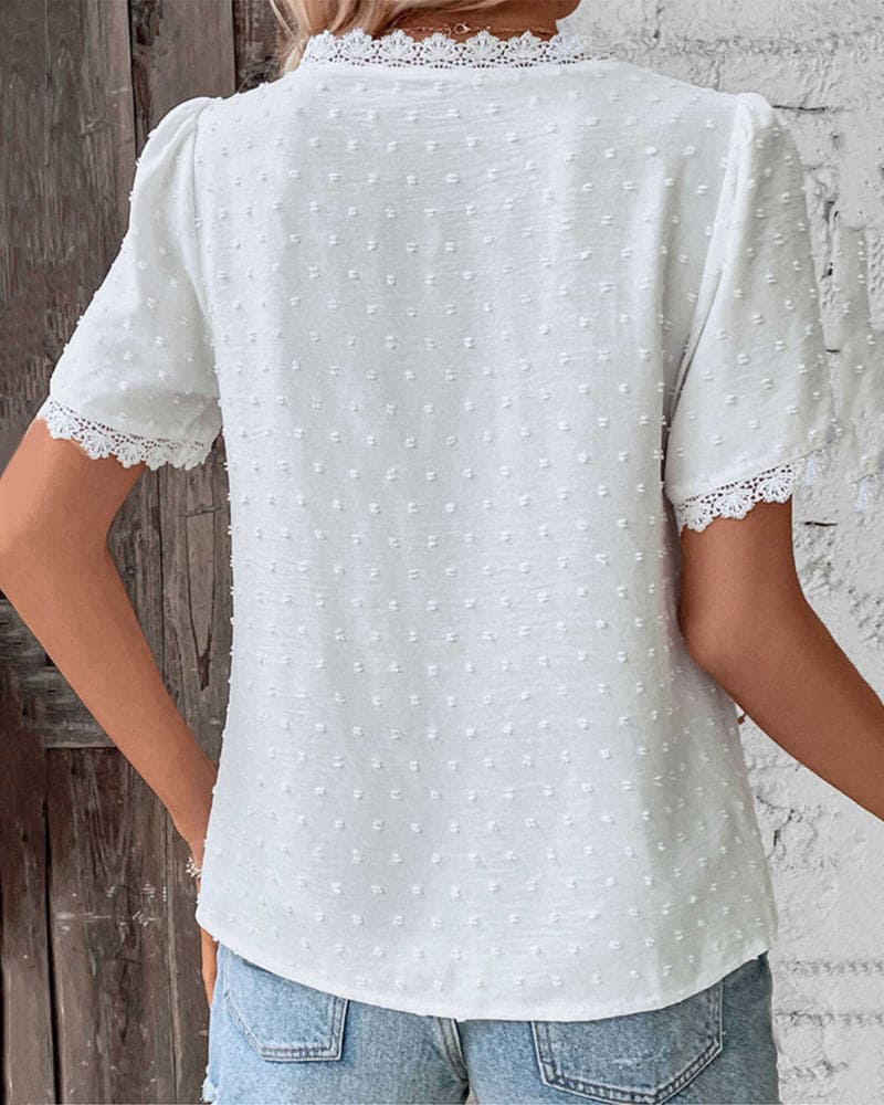 Lightweight women's blouse featuring a lace trim V-neck and Swiss dot texture, perfect for casual summer wear. 2