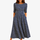 Womens navy floral print maxi dress featuring a flowing silhouette and convenient side pockets, perfect for summer events. 0