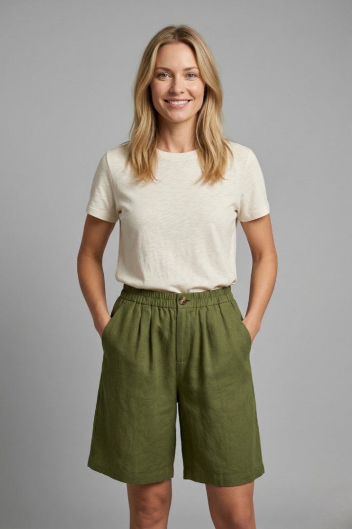 Womens linen shorts featuring an elastic waist and side pockets, designed for a relaxed fit perfect for warm weather. 0