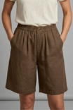 Womens linen shorts featuring an elastic waist and side pockets, designed for a relaxed fit perfect for warm weather. 11