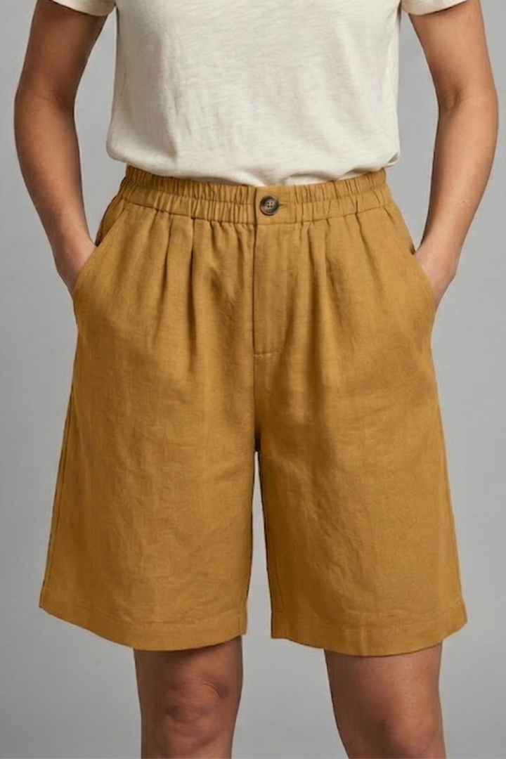 Womens linen shorts featuring an elastic waist and side pockets, designed for a relaxed fit perfect for warm weather. 13