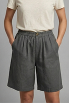 Womens linen shorts featuring an elastic waist and side pockets, designed for a relaxed fit perfect for warm weather. 3