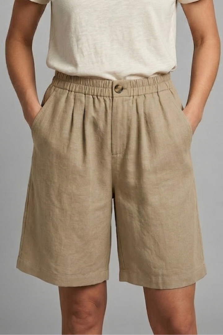 Womens linen shorts featuring an elastic waist and side pockets, designed for a relaxed fit perfect for warm weather. 5