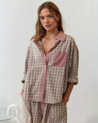 Womens pyjamas set featuring a relaxed fit, made from soft breathable fabric, with full-length trousers available in pink or blue. 2