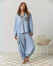 Womens pyjamas set featuring a relaxed fit, made from soft breathable fabric, with full-length trousers available in pink or blue. 5