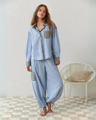 Womens pyjamas set featuring a relaxed fit, made from soft breathable fabric, with full-length trousers available in pink or blue. 5