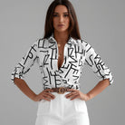 Womens lightweight printed blouse featuring a classic collar and roll-up sleeves, designed for a relaxed fit ideal for casual or semi-formal occasions. 0