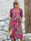 Womens summer dress featuring a V-neck design and a vibrant floral pattern, knee-length, made from soft fabric, and includes convenient side pockets. 2