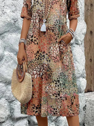 Womens summer dress featuring a V-neck design and a vibrant floral pattern, knee-length, made from soft fabric, and includes convenient side pockets. 6