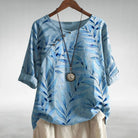Womens soft blue linen-look short sleeve blouse featuring a relaxed fit and vibrant floral print, perfect for casual summer outings. 0