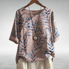 Womens soft blue linen-look short sleeve blouse featuring a relaxed fit and vibrant floral print, perfect for casual summer outings. 2