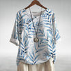 Womens soft blue linen-look short sleeve blouse featuring a relaxed fit and vibrant floral print, perfect for casual summer outings. 3