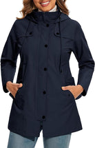 Womens waterproof coat featuring an adjustable waist and hood, designed with a stylish plaid lining, perfect for rainy days and outdoor activities. 2